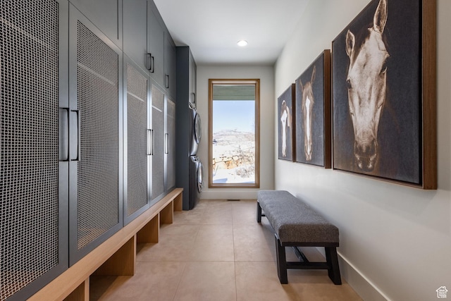 9791 N Uinta Dr, Kamas, UT 84036 - mudroom with stacked washer and clothes dryer, baseboards, recessed lighting, and light tile patterned floors
