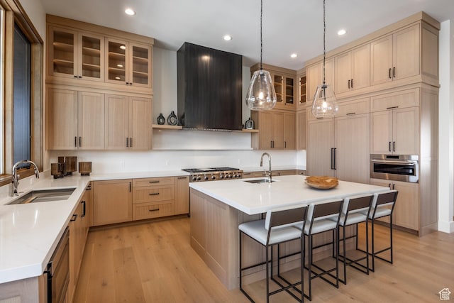 9791 N Uinta Dr, Kamas, UT 84036 - kitchen featuring light brown cabinets, a sink, a kitchen bar, stainless steel appliances, and extractor fan