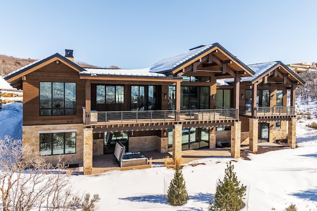 9791 N Uinta Dr, Kamas, UT 84036 - snow covered house featuring stone siding and a patio area