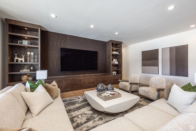 9791 N Uinta Dr, Kamas, UT 84036 - living room featuring wood finished floors, built in features, an accent wall, and recessed lighting