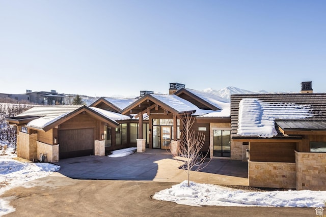 9791 N Uinta Dr, Kamas, UT 84036 - view of front facade with stone siding, a garage, and concrete driveway