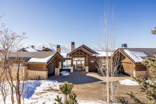 9791 N Uinta Dr, Kamas, UT 84036 - snow covered property with a chimney, a tile roof, and a mountain view