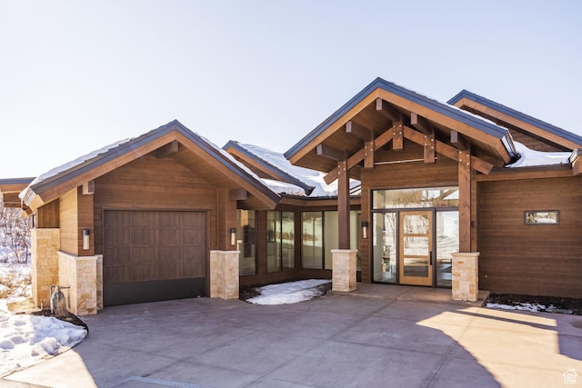 9791 N Uinta Dr, Kamas, UT 84036 - view of front of property featuring stone siding, driveway, and a garage