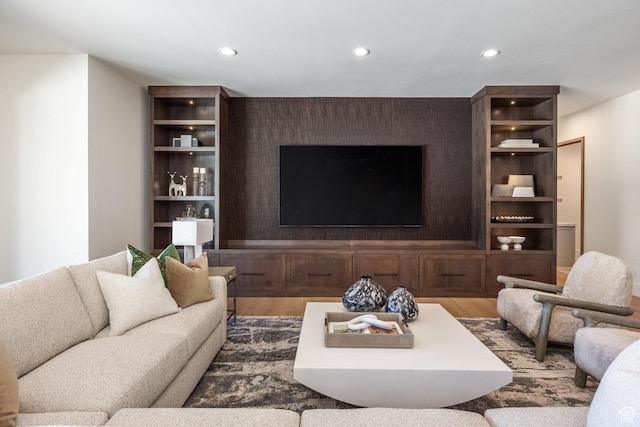 9791 N Uinta Dr, Kamas, UT 84036 - living area featuring wood finished floors, an accent wall, and recessed lighting