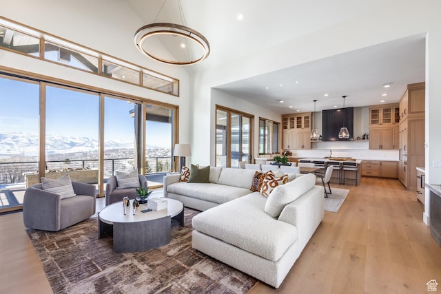 9791 N Uinta Dr, Kamas, UT 84036 - living area featuring light wood finished floors, recessed lighting, a towering ceiling, and a mountain view