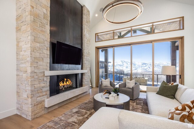 9791 N Uinta Dr, Kamas, UT 84036 - living room featuring light wood-style flooring, high vaulted ceiling, baseboards, and a fireplace