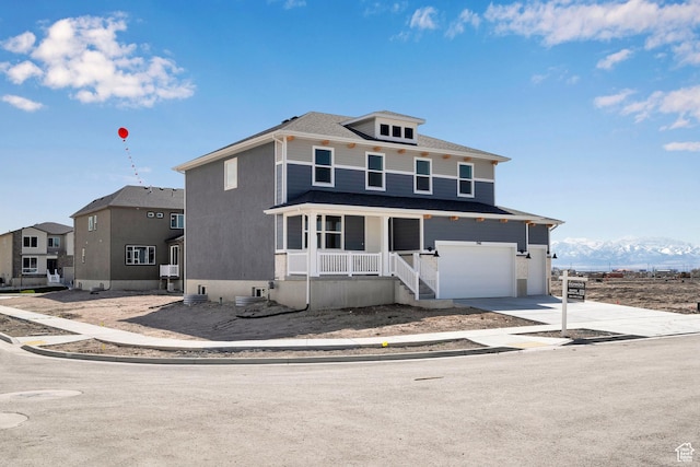 1946 E Burger St Unit 1237, Lake Point, UT 84074 - view of front facade featuring covered porch, an attached garage, driveway, and a mountain view