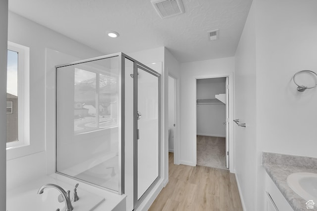 1946 E Burger St Unit 1237, Lake Point, UT 84074 - bathroom with a stall shower, a spacious closet, wood finished floors, vanity, and baseboards