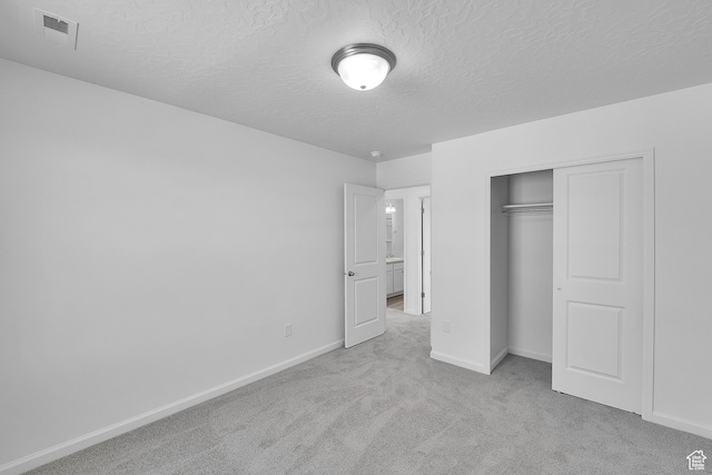 1946 E Burger St Unit 1237, Lake Point, UT 84074 - unfurnished bedroom with carpet flooring, a textured ceiling, baseboards, and a closet