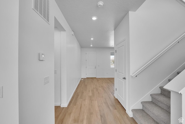 1946 E Burger St Unit 1237, Lake Point, UT 84074 - hallway featuring light wood-style flooring, baseboards, stairway, and recessed lighting