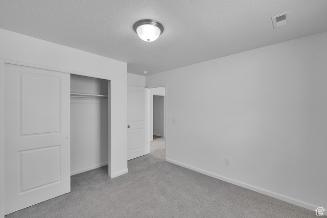 1946 E Burger St Unit 1237, Lake Point, UT 84074 - unfurnished bedroom with carpet floors, baseboards, a closet, and a textured ceiling