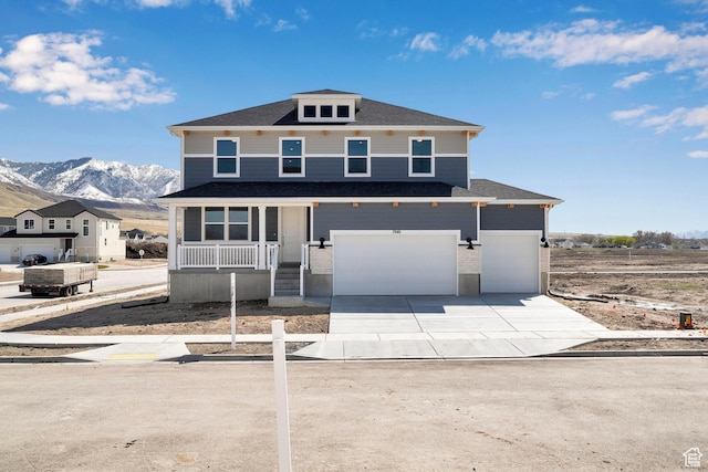 1946 E Burger St Unit 1237, Lake Point, UT 84074 - view of front facade featuring driveway, a mountain view, covered porch, a garage, and roof with shingles