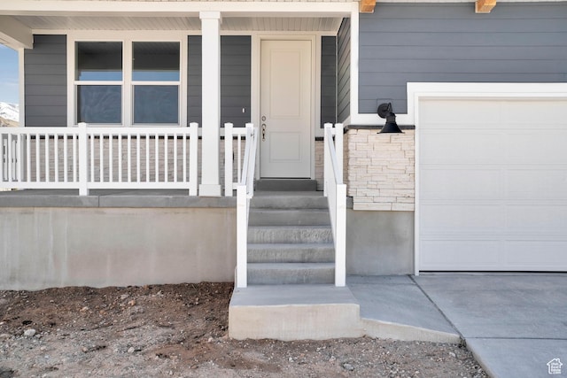 1946 E Burger St Unit 1237, Lake Point, UT 84074 - property entrance featuring an attached garage and a porch