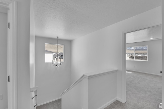 1946 E Burger St Unit 1237, Lake Point, UT 84074 - detailed view of carpet flooring, a chandelier, a textured ceiling, and baseboards