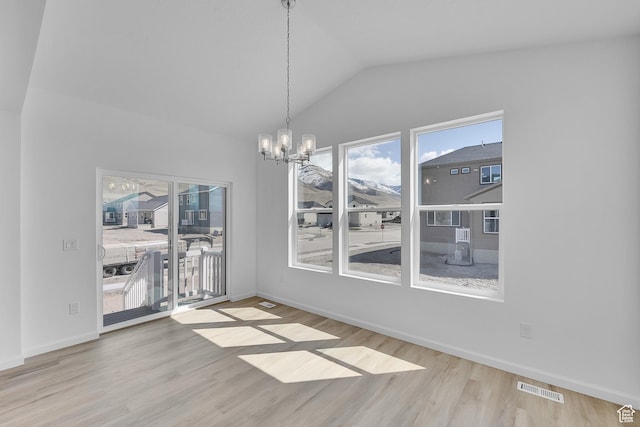 1946 E Burger St Unit 1237, Lake Point, UT 84074 - unfurnished dining area with a chandelier, wood finished floors, lofted ceiling, and baseboards