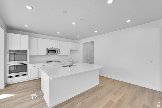 1946 E Burger St Unit 1237, Lake Point, UT 84074 - kitchen featuring stainless steel appliances, white cabinets, light wood-style flooring, recessed lighting, and light countertops