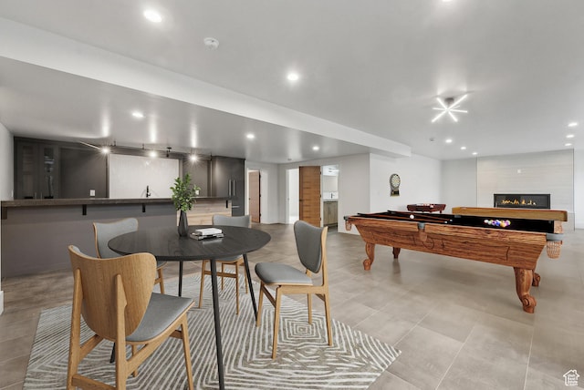 rec room featuring recessed lighting, pool table, and a fireplace
