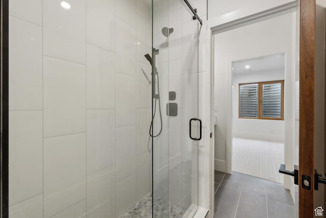 full bathroom featuring tile patterned flooring and a shower stall