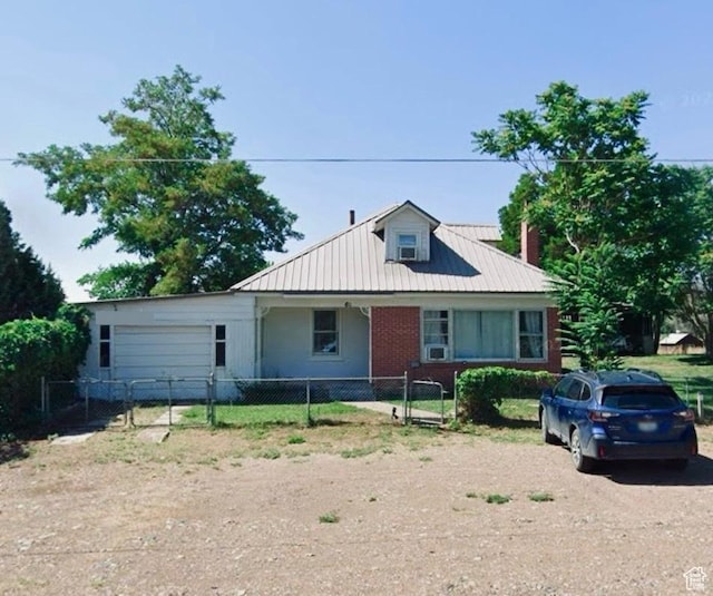 view of front of house featuring an attached garage, driveway, fence private yard, and a gate