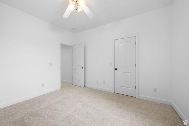 unfurnished bedroom featuring ceiling fan and light colored carpet