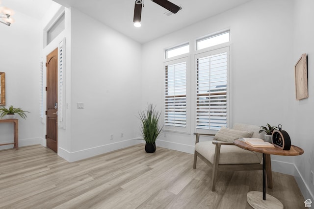 sitting room featuring light hardwood / wood-style flooring and ceiling fan