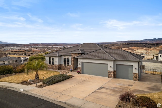 view of front facade with a mountain view and a garage