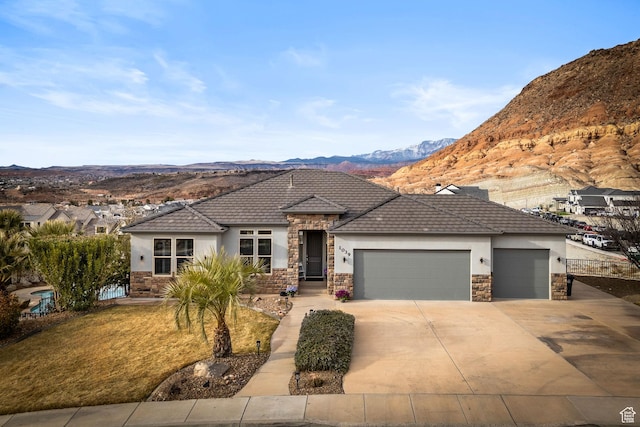 view of front of property featuring a mountain view and a garage