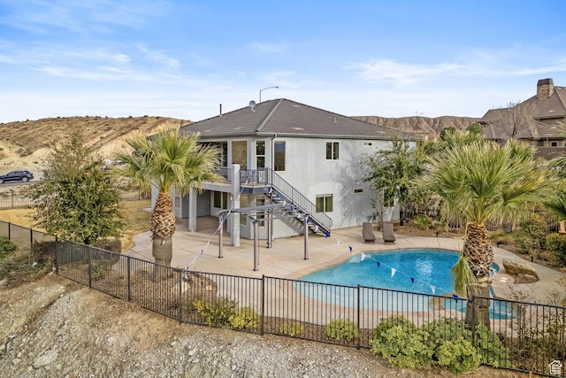 view of pool with a mountain view and a patio