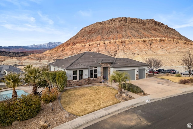 view of front facade with a mountain view and a garage