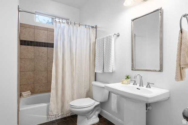 bathroom featuring toilet, shower / tub combo, and tile patterned flooring