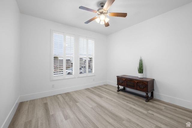 empty room featuring light wood-type flooring and ceiling fan