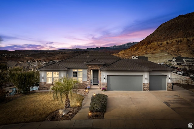 prairie-style house featuring a mountain view and a garage