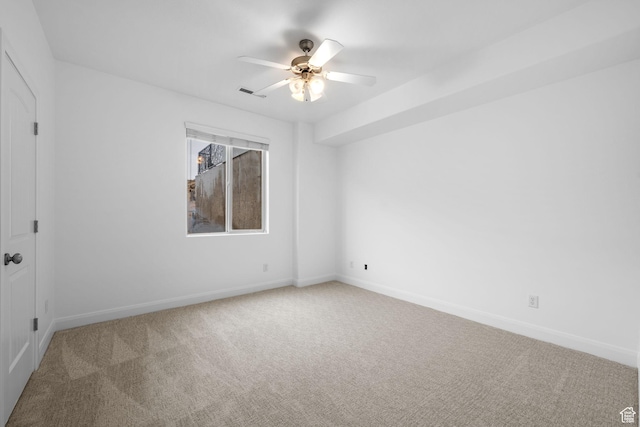 carpeted spare room featuring ceiling fan