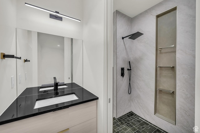 bathroom with vanity and tiled shower