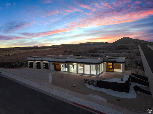 back house at dusk featuring a mountain view