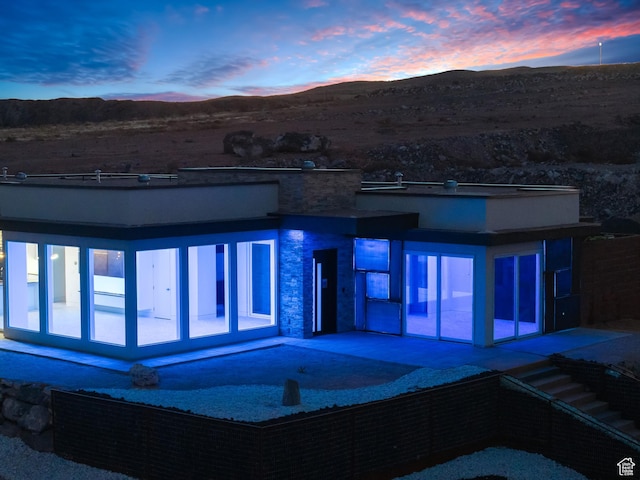 exterior space with a mountain view and a patio area