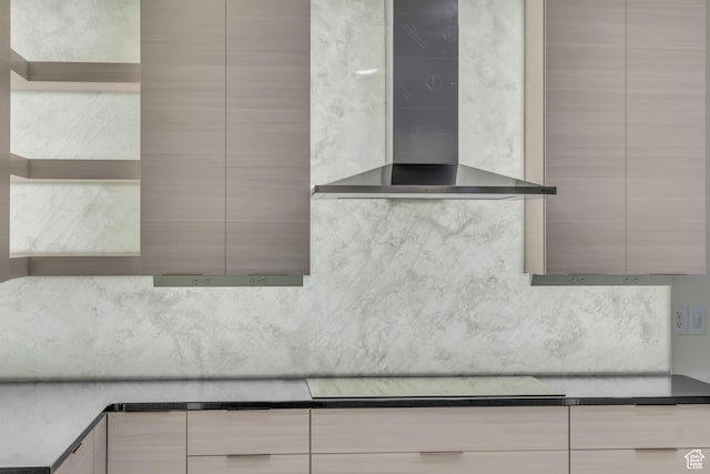 details with stovetop, decorative backsplash, and wall chimney range hood