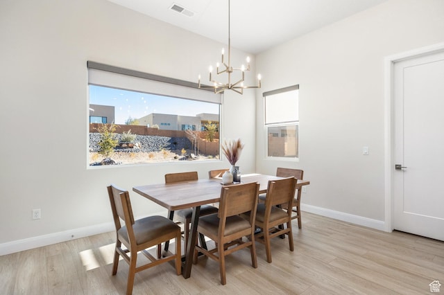 dining area featuring a notable chandelier and light hardwood / wood-style floors