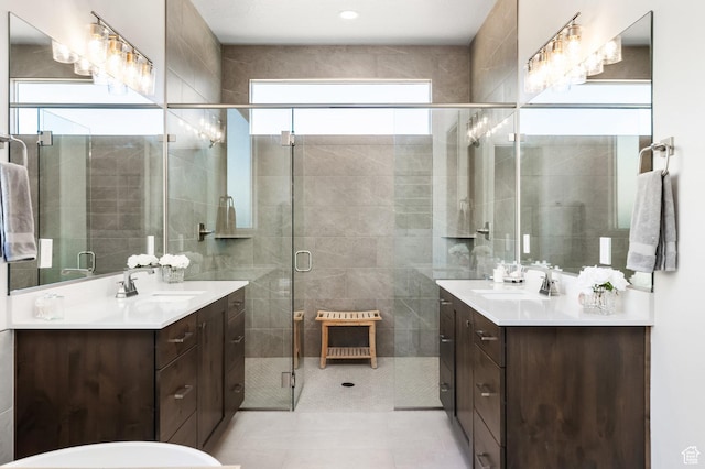 bathroom featuring vanity and a shower with door