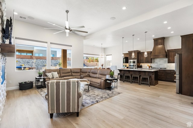 living room featuring ceiling fan and light wood-type flooring