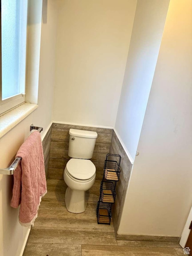 4863 W 3280 S, West Valley City, UT 84120 - half bathroom featuring toilet, a wainscoted wall, and wood finished floors