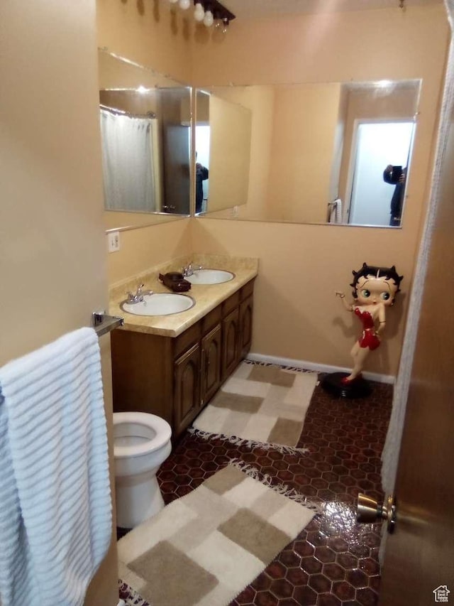 bathroom featuring vanity and toilet