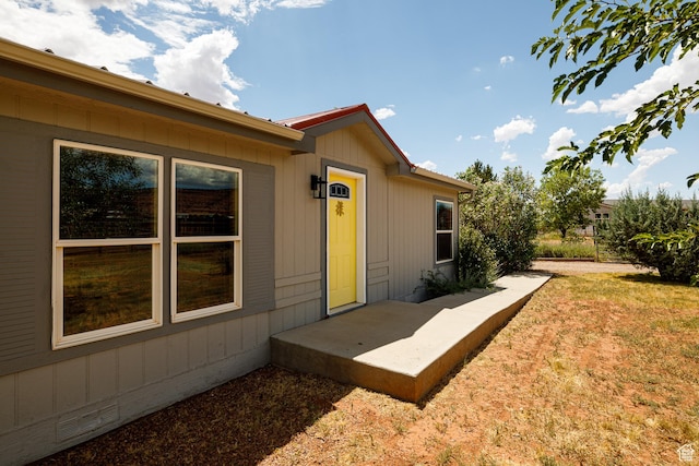 doorway to property featuring a yard