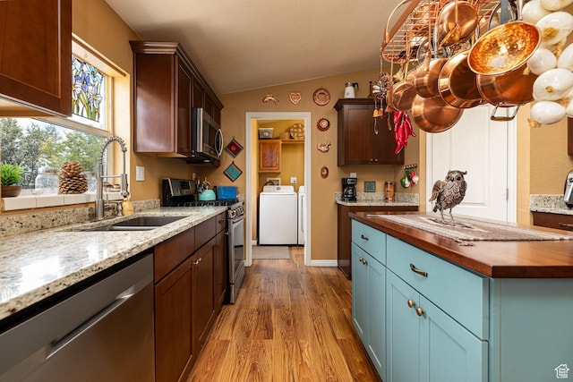 1361 S Roadrunner Cir, Kanab, UT 84741 - kitchen featuring butcher block countertops, sink, stainless steel appliances, washer and dryer, and vaulted ceiling