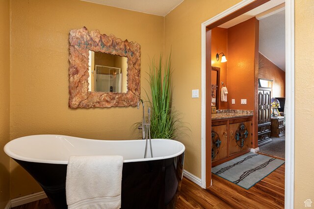 1361 S Roadrunner Cir, Kanab, UT 84741 - bathroom featuring vanity, a tub to relax in, and wood-type flooring