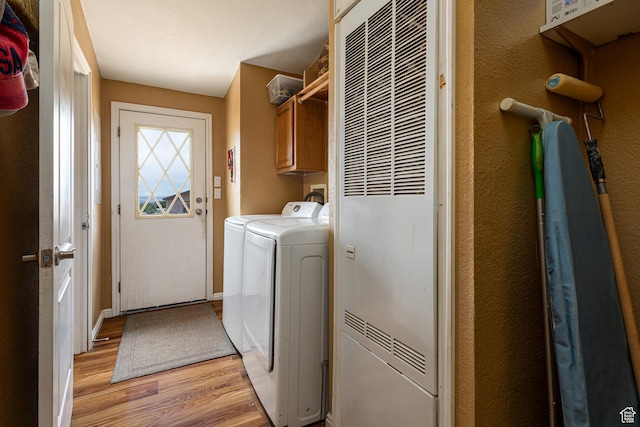 1361 S Roadrunner Cir, Kanab, UT 84741 - clothes washing area with independent washer and dryer, light hardwood / wood-style flooring, and cabinets