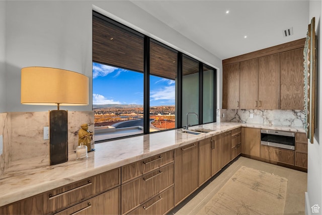 63 E Colima Rd, Washington, UT 84780 - kitchen featuring backsplash, light stone counters, and recessed lighting