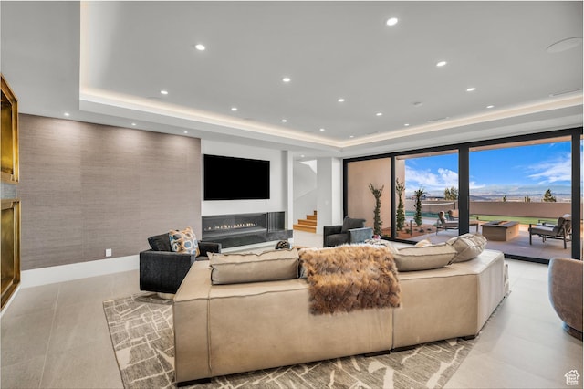 63 E Colima Rd, Washington, UT 84780 - living area featuring a raised ceiling, recessed lighting, a premium fireplace, and stairs