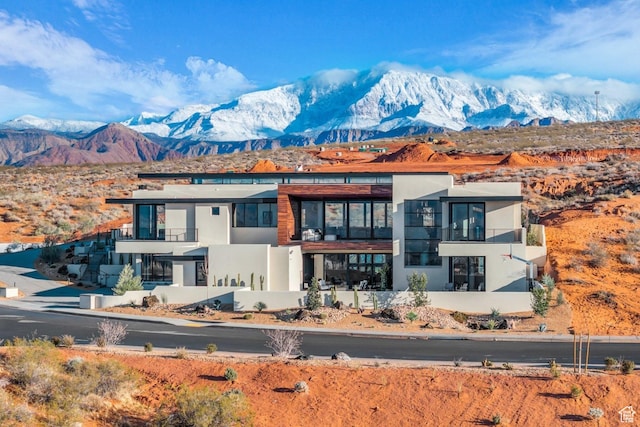 63 E Colima Rd, Washington, UT 84780 - view of front facade featuring a mountain view, a balcony, and stucco siding