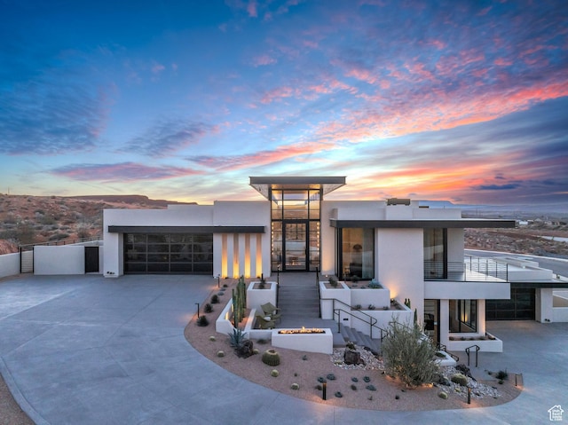 63 E Colima Rd, Washington, UT 84780 - modern home with stucco siding, a garage, driveway, and a balcony